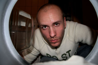 Man looking into washing machine