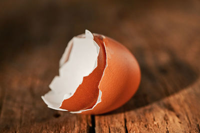 Abstract egg shell cracked in two parts on wooden table