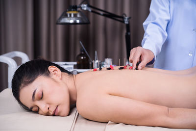 Midsection of shirtless man lying down