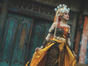 Woman standing against building