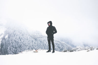 People standing on snow covered landscape