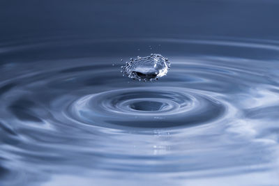 Close-up of two water drops clashing into each other