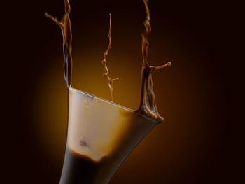 Close-up of drink glass against black background