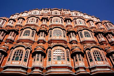 Low angle view of hawa mahal against clear blue sky during sunny day