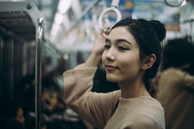 Portrait of beautiful young woman in train