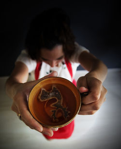 Young woman holding tea cup