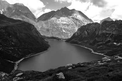 Scenic view of lake amidst mountains against sky