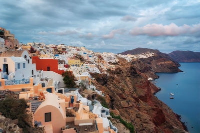 High angle view of townscape by sea against sky