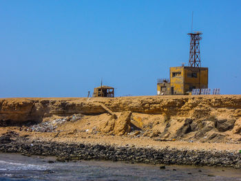 Construction site against clear blue sky