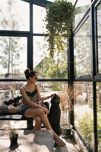 Woman sitting by window