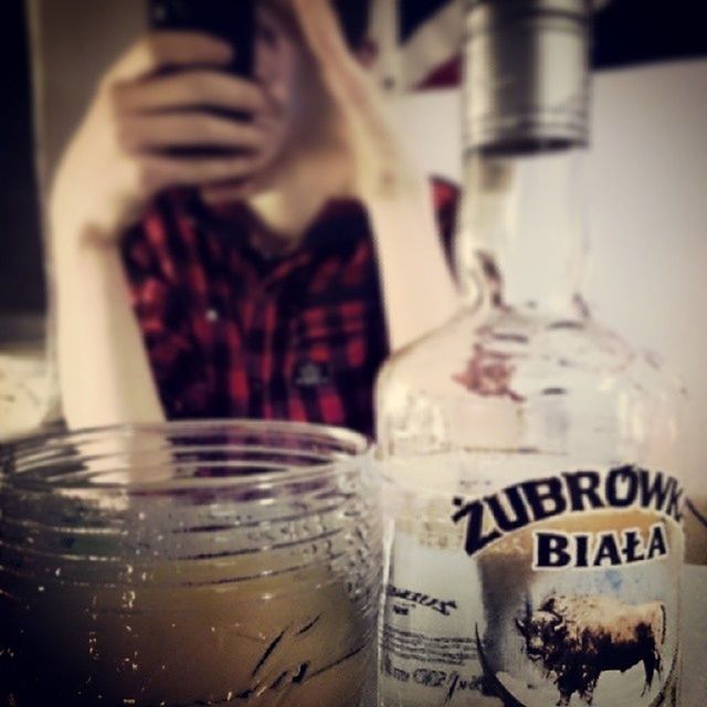 indoors, drink, glass - material, refreshment, drinking glass, transparent, food and drink, text, close-up, western script, still life, focus on foreground, alcohol, bottle, table, freshness, glass, communication, selective focus, jar