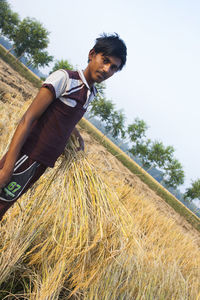 Low angle view of man on field against sky