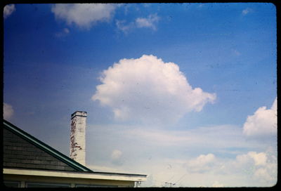 Low angle view of building against cloudy sky