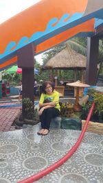 Portrait of smiling girl sitting outdoors