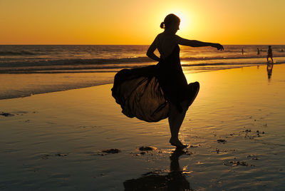 Woman on beach during sunset