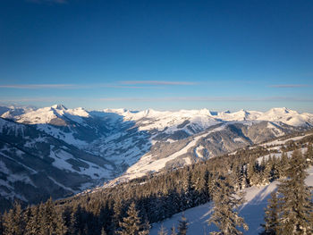 Scenic view of snowcapped mountains against blue sky