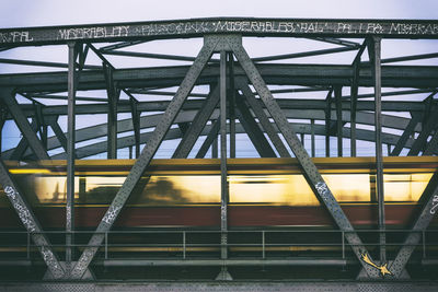 Low angle view of train on bridge against sky