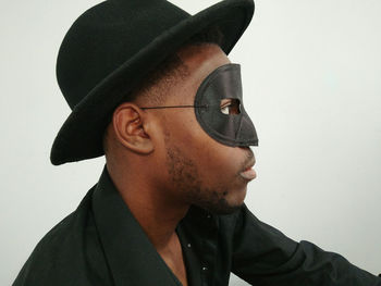 Close-up portrait of young man against white background