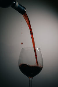 Close-up of beer glass bottle against white background