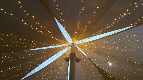 Low angle view of illuminated lights hanging from ceiling