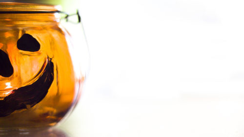 Close-up of orange glass on table