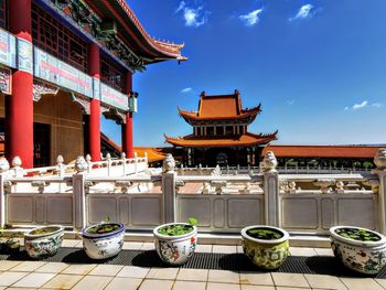 Chinese water pots with view of  temple