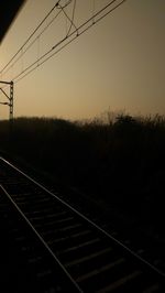 Railroad tracks against sky during sunset