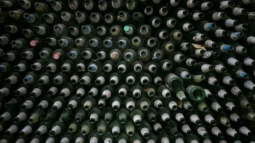 Full frame shot of wine bottles at winery