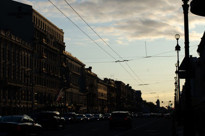 Traffic on road against buildings in city