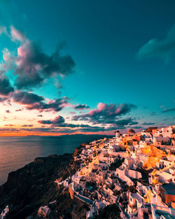 High angle view of townscape by sea against sky