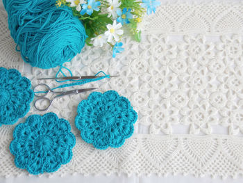 High angle view of wool with scissors and fabric on table