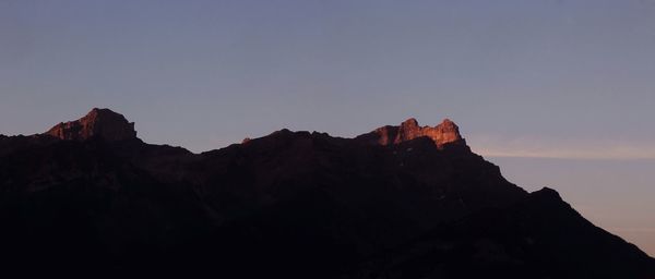 Scenic view of silhouette mountains against clear sky