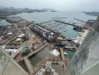 High angle view of buildings by sea against sky