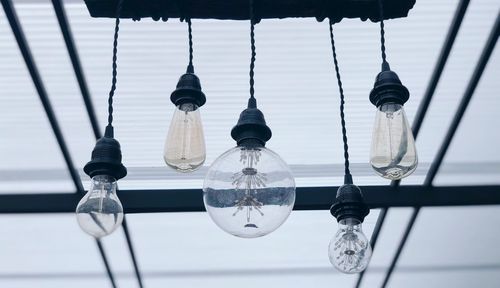 Low angle view of light bulbs hanging on ceiling