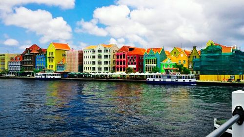 Boats in river with buildings in background