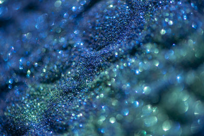 Abstract glitter lights colorful bokeh background in blue and green color tones