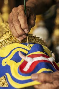Cropped hand of woman holding christmas decoration