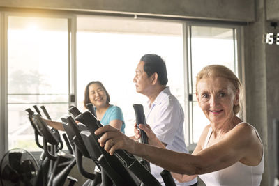 Portrait of smiling woman exercising at gym