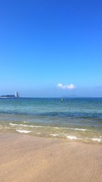 Scenic view of sea against blue sky