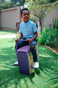 Full length of boy sitting on toy at park