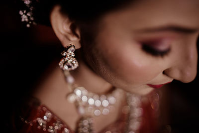 Close-up of young woman with pearl jewelry