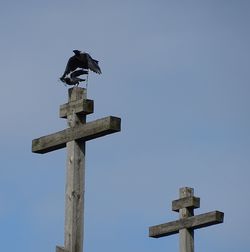Low angle view of cross against clear sky