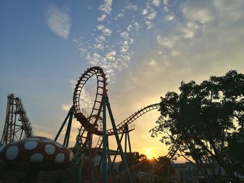 Ferris wheel against sky at sunset