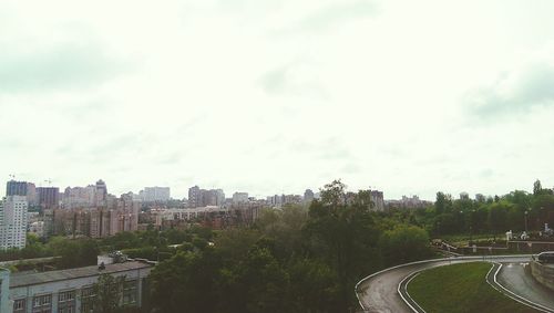 Cityscape against cloudy sky