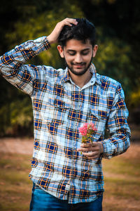 Young man holding flowers