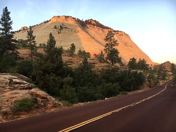 Road by mountain against sky