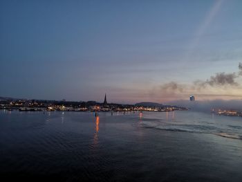 Scenic view of sea against buildings in city