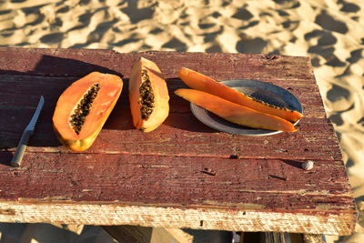 Eating fresh cut papaya on the beach