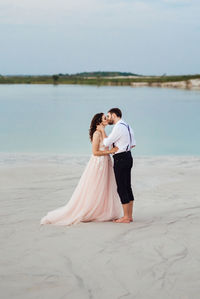 Rear view of couple kissing in water