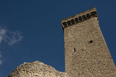 Low angle view of castle against blue sky